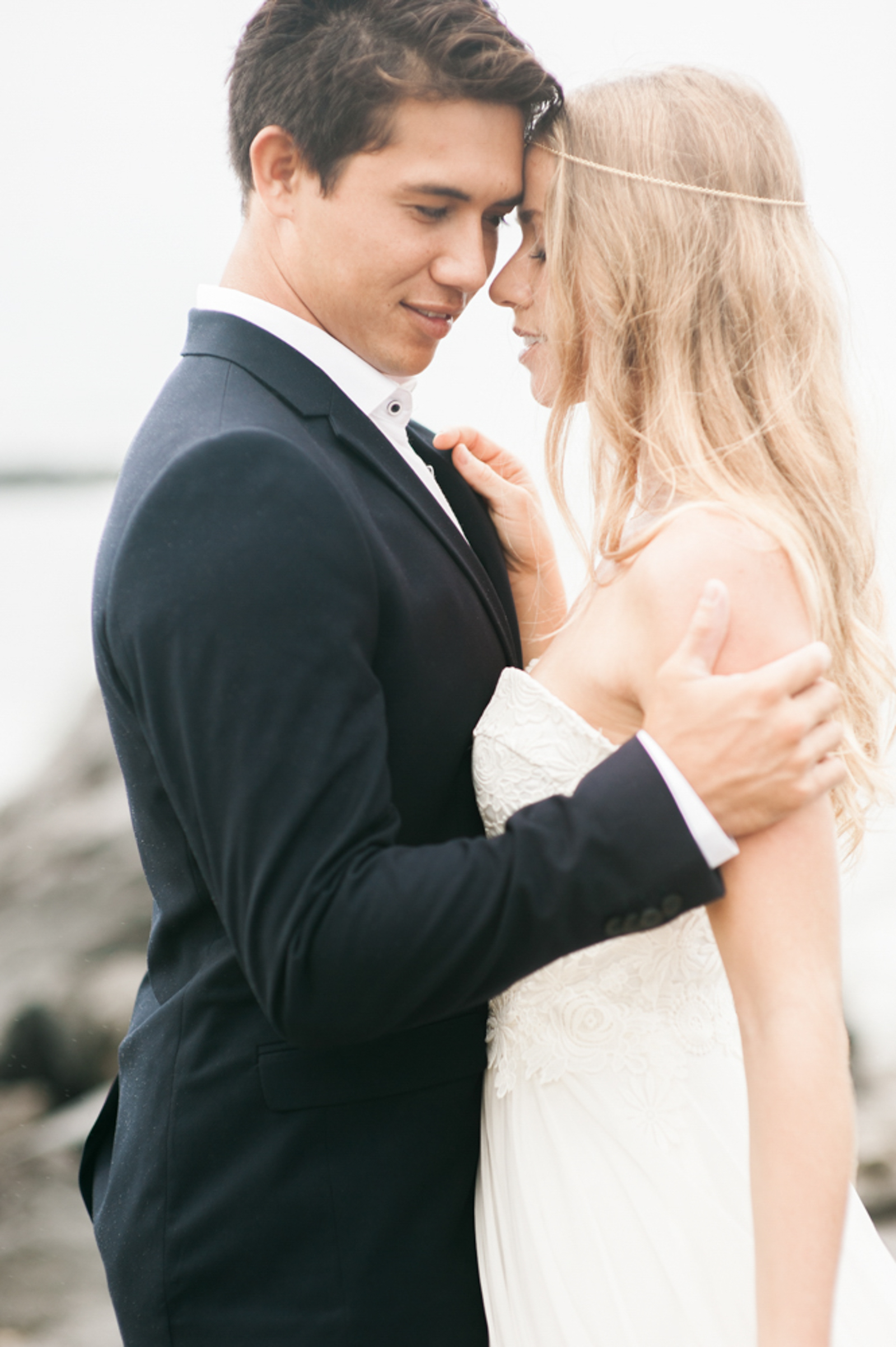 bride and groom on Waikiki beach on the rock barrier n stormy weather